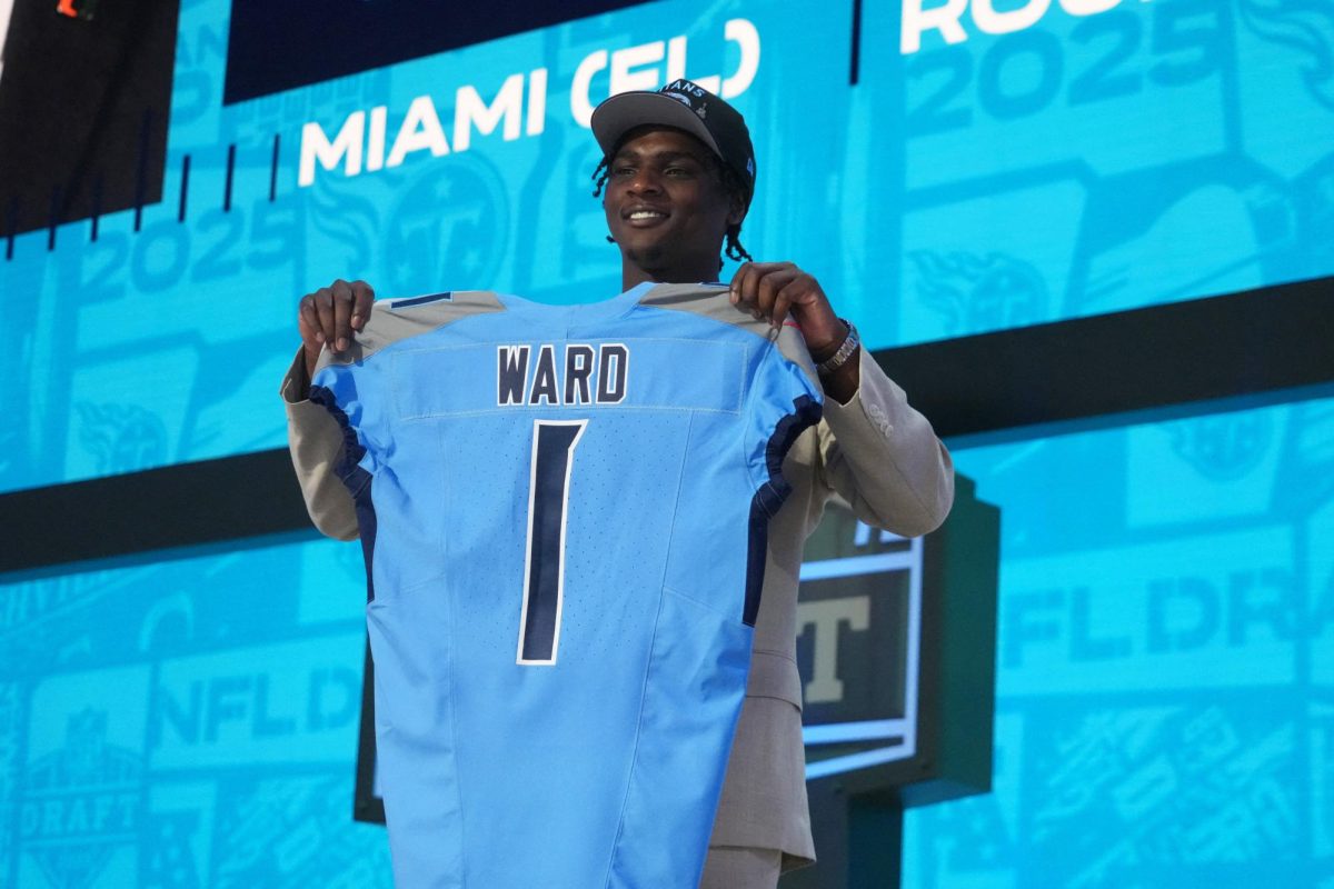 Apr 24, 2025; Green Bay, WI, USA; Miami Hurricanes quarterback Cameron Ward holds the jersey on stage after he is selected by the Tennessee Titans as the number one pick in the first round of the 2025 NFL Draft at Lambeau Field. Mandatory Credit: Kirby Lee-Imagn Images